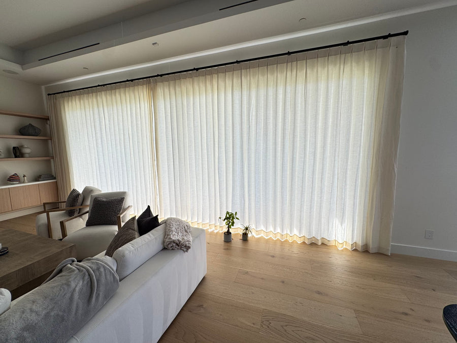 Sheer linen-look drapery filtering afternoon light in a living room