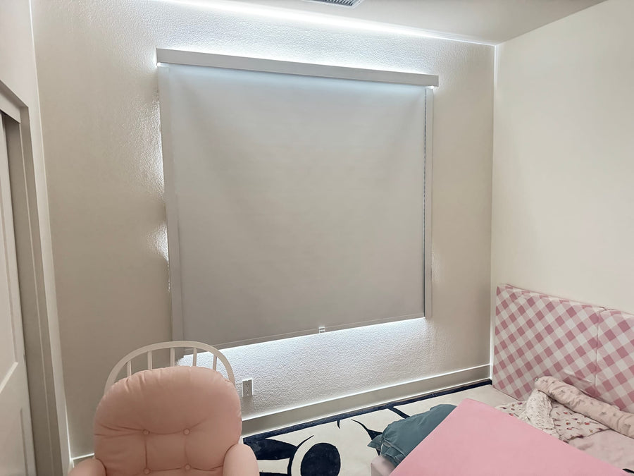 Wide square window in a child's bedroom fitted with a blackout roller shade