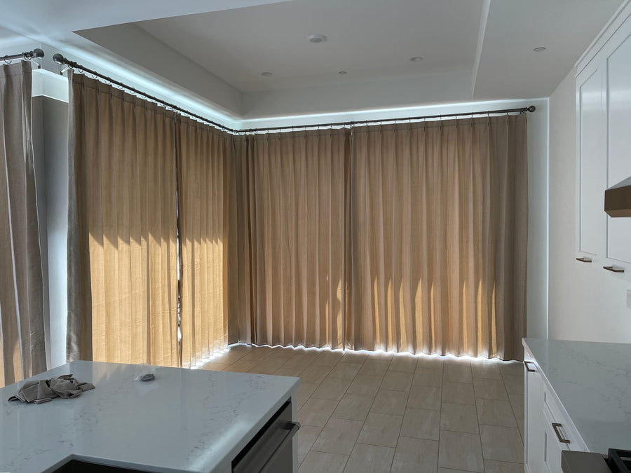 Afternoon sun filtering through corner drapery in the open living area