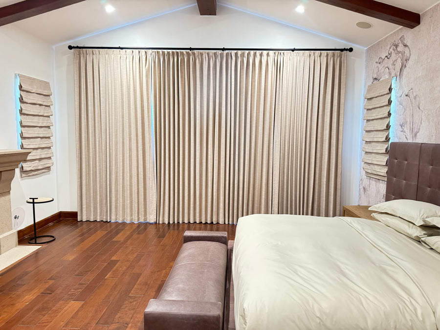 The same drapery drawn closed across the full wall at night