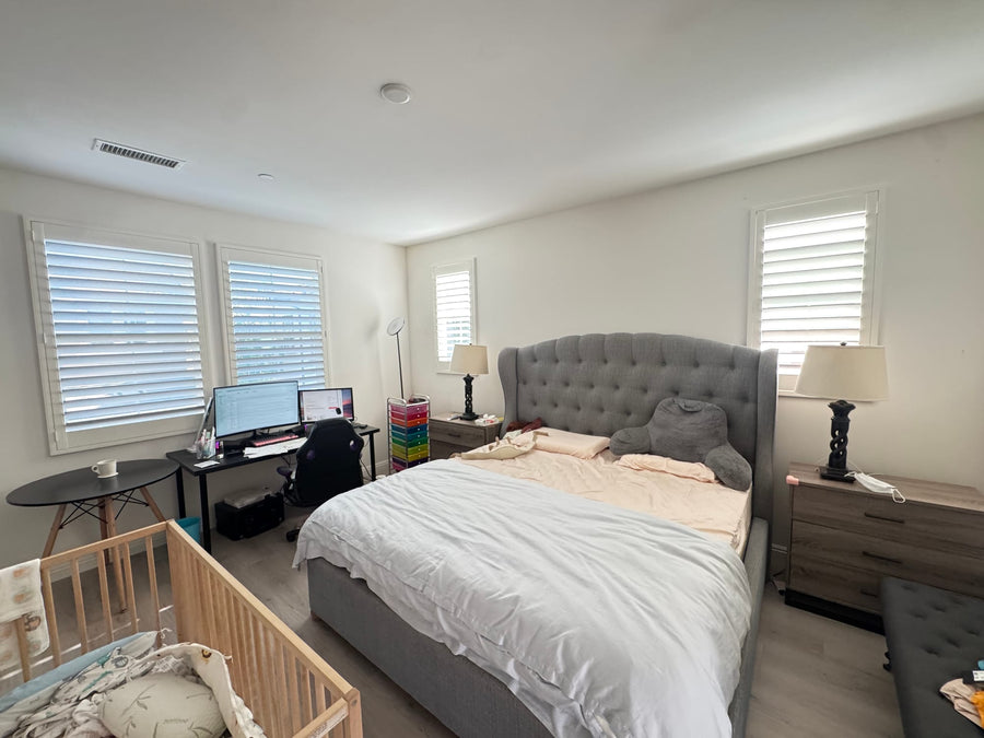 Primary bedroom with shutters on paired, narrow and corner windows