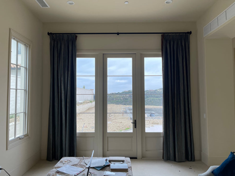Deep pewter lined panels framing a French door with a hillside view