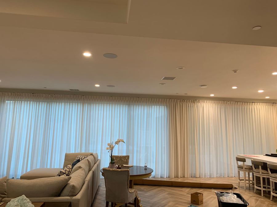 Corner view of continuous sheer panels running across two window walls